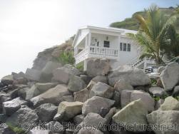 House in white at end of Monkey Bar Beach in St Kitts.jpg