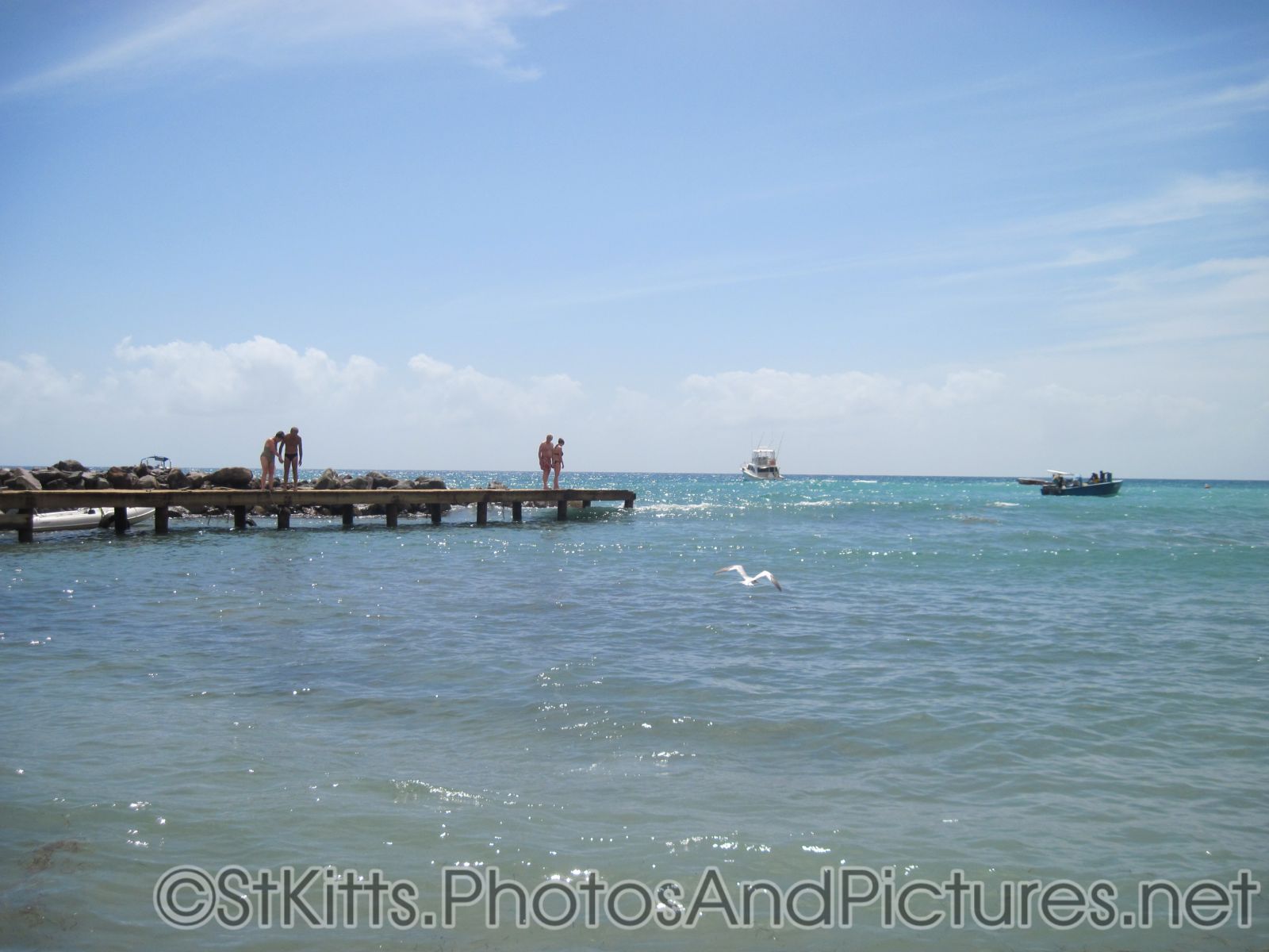 People standing on a pier at the Monkey Bar Beach in St Kitts.jpg
