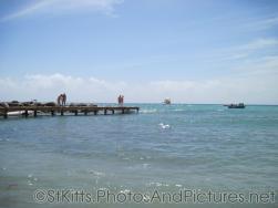 People standing on a pier at the Monkey Bar Beach in St Kitts.jpg