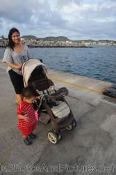 Darwin holds on to the stroller next to Mommy on cruise pier in St Kitts.jpg