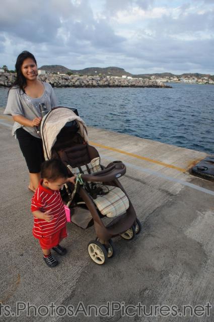 Darwin holds on to the stroller next to Mommy on cruise pier in St Kitts.jpg
