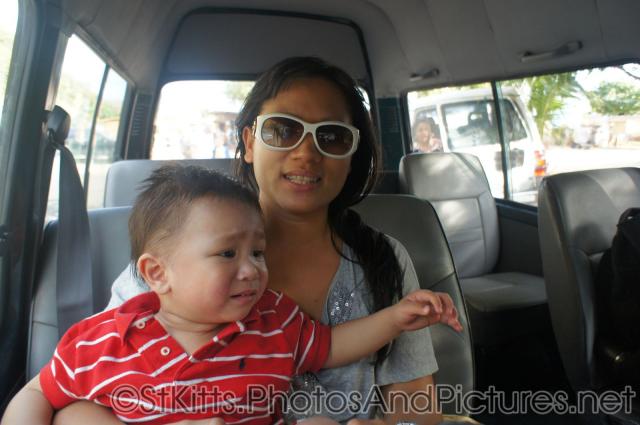 Darwin looks unhappy as mommy holds him in tour van in St Kitts.jpg
