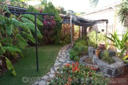 Walkway and tropical plants at Palm Court Gardens in Basseterre St Kitts.jpg