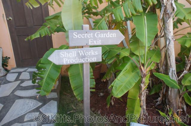 Sign pointing to Secret Garden and Shell Works Production at Palm Court Gardens in Basseterre St Kitts.jpg

